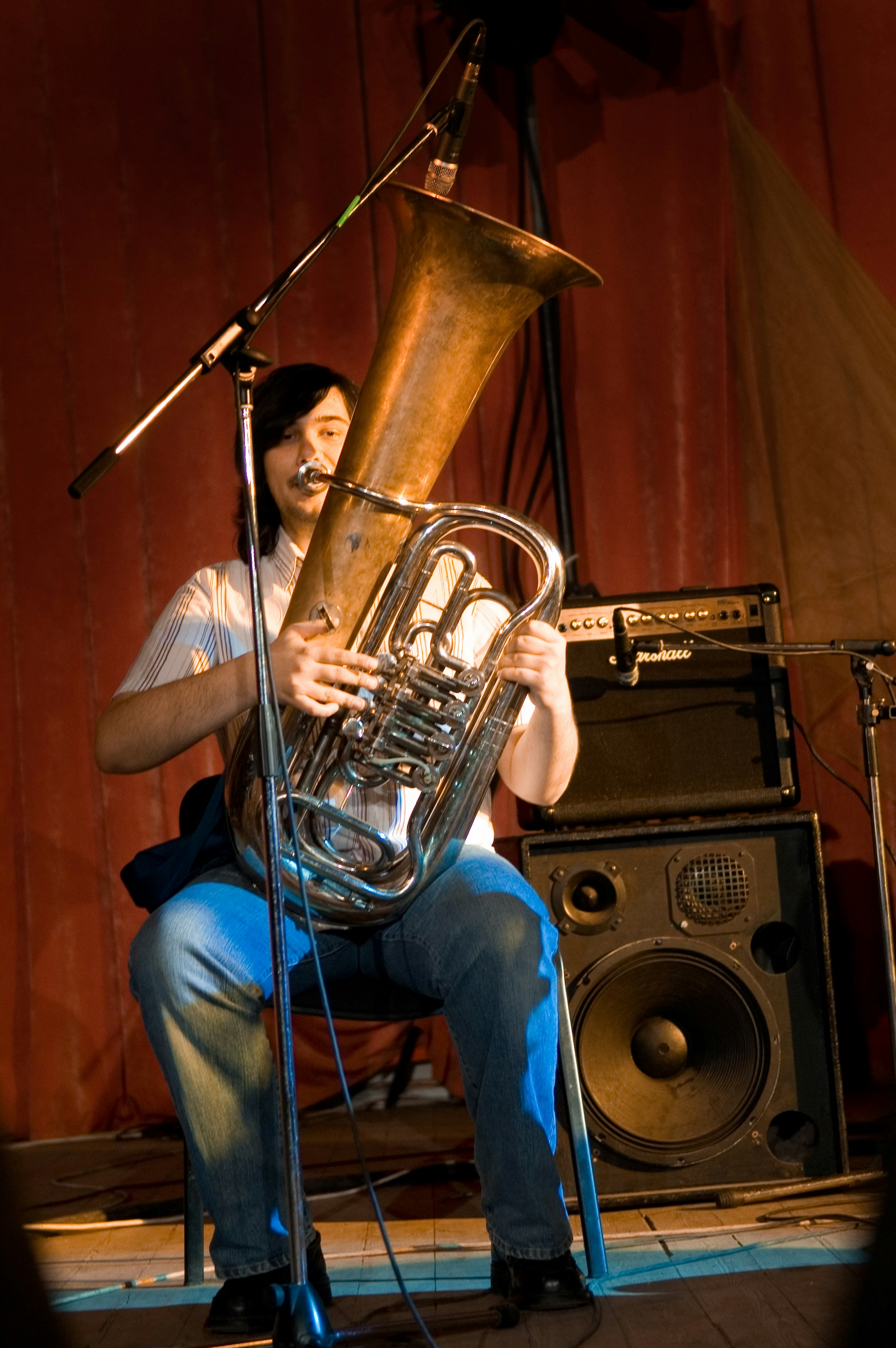 woman in blue denim jeans playing brass trumpet